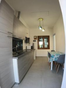 a kitchen with a table and a dining room at Appartamento Marina in Portoferraio