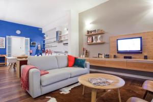 uma sala de estar com um sofá e uma televisão em Premium Design Central Suite em Valletta
