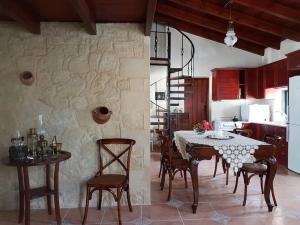 a kitchen and dining room with a table and chairs at Vivian's House for relaxing holidays in Nature in Kissamos