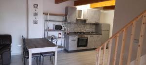 a small kitchen with a table and a counter top at Villa Maria in Marconia