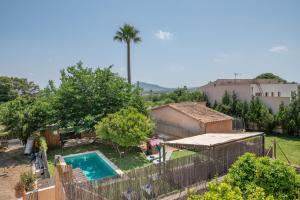 a backyard with a swimming pool and a fence at Villa Ca Na Campins in Campanet