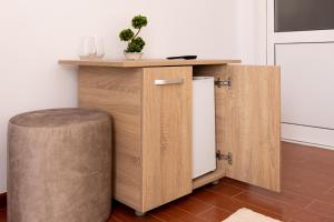 a kitchen with a counter with a stool and a table at MARCONI GUESTHOUSE in Hunedoara