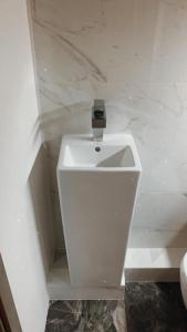 a white toilet in a bathroom with marble walls at MB Boutique Apartment Gdansk in Gdańsk