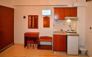 a small kitchen with a sink and a table at VILLA Vasilios EXARHOS in Paralia Katerinis