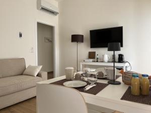 a living room with a table and a couch at 4B B&B in Fasano
