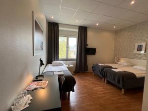 Postel nebo postele na pokoji v ubytování Sidsjö Hotell & Konferens