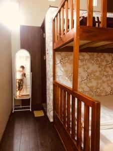 a room with a staircase and a bunk bed at Khang Homestay in Da Nang
