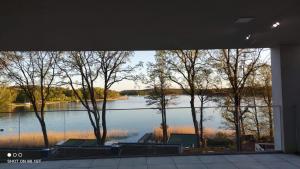 a view of a lake through a window at LOFT STRANDA in Giżycko