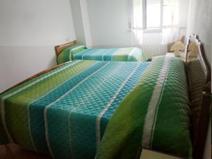 Letto o letti in una camera di B&B L'uva Fragolina