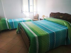 Letto o letti in una camera di B&B L'uva Fragolina