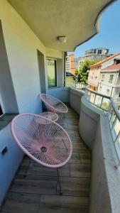 a balcony with two chairs and a table on a balcony at Centrally Located Apartment in Varna in Varna City