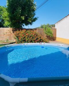 a swimming pool in a yard next to a fence at Às Portas da Vila in Monsaraz