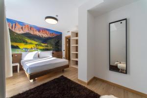 A bed or beds in a room at YUGOGO PELLICO 8 Trento Centro