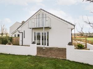 a white house with a fence at The Annex in Ulverston