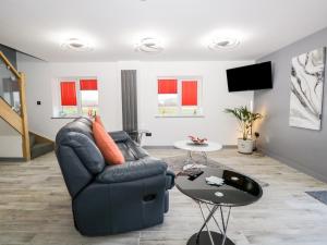 a living room with a couch and a table at The Annex in Ulverston