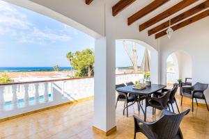 a dining room with a view of the ocean at Villa Sol y Sombra by Escape Home in Son Bou