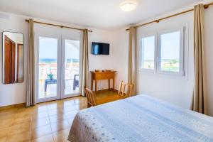 a bedroom with a bed and a view of the ocean at Villa Sol y Sombra by Escape Home in Son Bou +23 photos