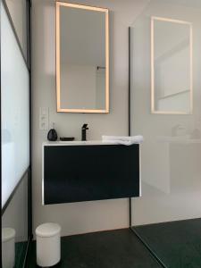 a bathroom with a sink and a mirror at Ultra-luxury penthouse with a generous terrace and breathtaking sea view T71 in Ostend