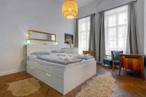 a bedroom with a large bed and a desk at Liberty Square Apartment in Budapest