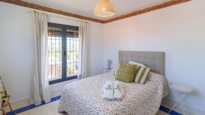 a bedroom with a bed with towels on it at Casa Trigueros Alozaina by Ruralidays in Alozaina +15 photos