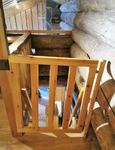 a wooden stair case in a room with a building at Rukanhelmi jr. in Ruka