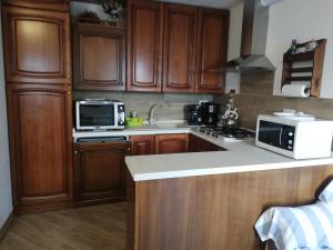 a kitchen with wooden cabinets and a white counter top at Casa Anna - Montemezzo in Bugiallo +19 photos