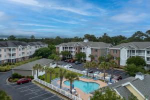an aerial view of a apartment complex with a pool and parking lot at Magnolia Pointe 305 in Myrtle Beach