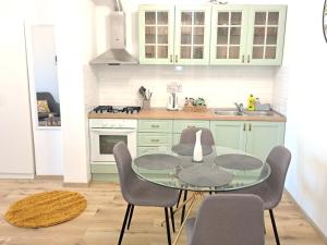 a kitchen with a glass table and chairs at Apartman Karmen in Vodice