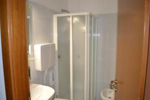 a bathroom with a shower and a toilet and a sink at GARNI ANNA in Besenello +21 photos