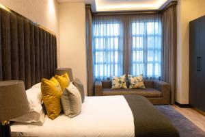 a bedroom with a large bed with yellow pillows at Zet On 9TH Avenue in Durban