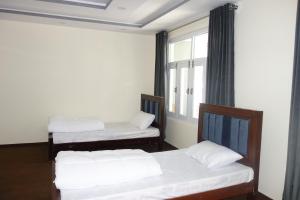 Postel nebo postele na pokoji v ubytování Alpen Hotel Skardu