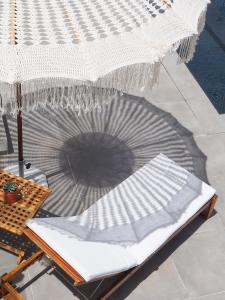 a chair with an umbrella on a patio at A Casa Brava in Santarém