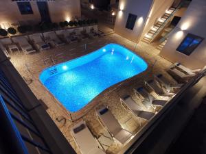 an overhead view of a swimming pool in a hotel at Anemos Villas in Mitika