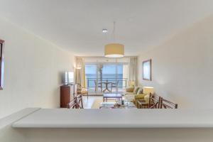 a living room with a view of the ocean at Tranquil Beachside Stay - Atlantic Gardens Beach in Funchal