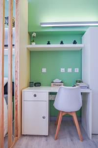 een bureau met een witte stoel in een slaapkamer bij L'HélleNid : Studio CONFORT Riom Centre in Riom