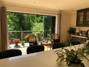 a living room with a large sliding glass door at Stunning Surrey Hills Country House set in half an acre in Hindhead