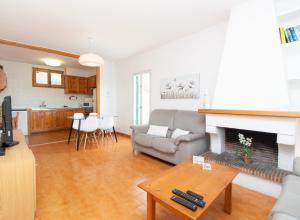a living room with a couch and a fireplace at Casa Cris by Sonne Villas in Ciutadella