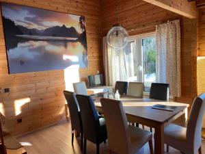 a dining room with a wooden table and chairs at Eifelcottage in Ulmen