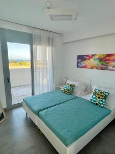 a bedroom with a bed with a view of the ocean at Kallipateira Villa in Lakhania