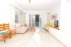 a living room with a couch and a tv at Casa Playa by Sonne Villas in Ferreries