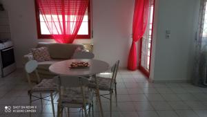 a living room with a table and a couch at Elea House in Keramoti