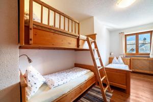 a bunk bed room with two beds and a ladder at Hof am Schloss Apartement Enzian in Montechiaro