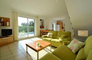 a living room with a couch and a table at Villa Azucena by Sonne Villas in Cala Galdana