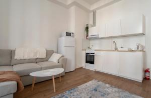 a living room with a couch and a table and a kitchen at Supreme Luxury Top Central 1 Bedroom Apartment in Sofia