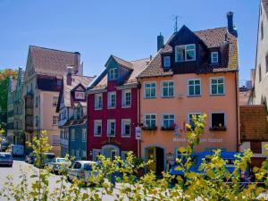 a group of buildings on a city street with cars at Hotel Garni Brugger in Lindau