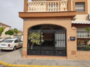 a building with a black door with a balcony at Montequinto apartamento 50m en Semisótano in Dos Hermanas