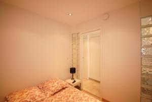 a bedroom with a bed and a wall with wine glasses at Résidence Gray d'Albion 2P NAP558 in Cannes