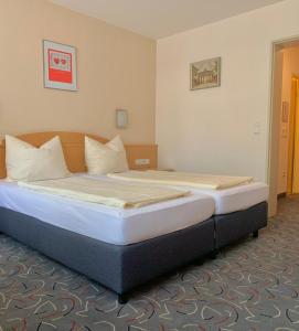 a bedroom with a large bed in a room at Hotel Garni Brugger in Lindau