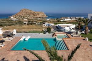 a swimming pool with a view of the ocean at Arkasa Palace in Arkasa