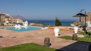 a swimming pool with a view of the ocean at Arkasa Palace in Arkasa